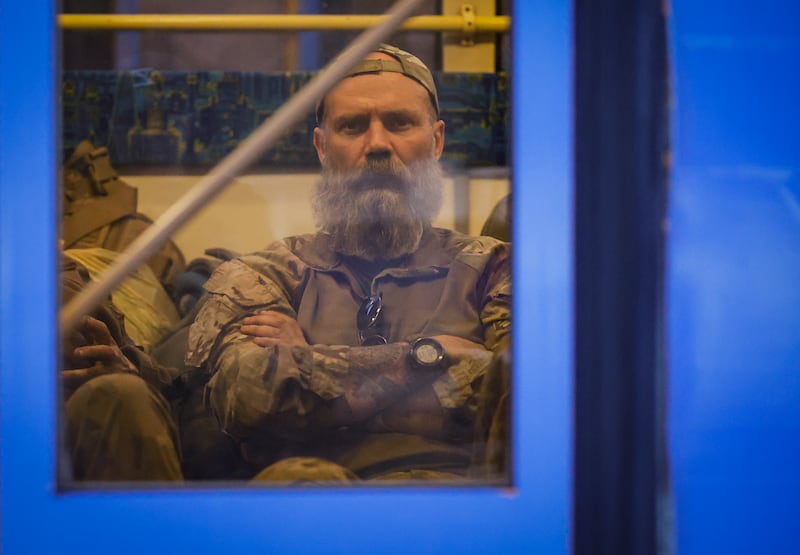 A Ukrainian soldier sits on a bus as troops are evacuated. EPA 