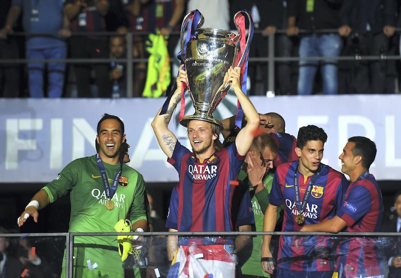 BERLIN, GERMANY - JUNE 06: Ivan Rakitic of Barcelona celebrates victory with the trophy after the UEFA Champions League Final between Juventus and FC Barcelona at Olympiastadion on June 6, 2015 in Berlin, Germany.  (Photo by Shaun Botterill/Getty Images)