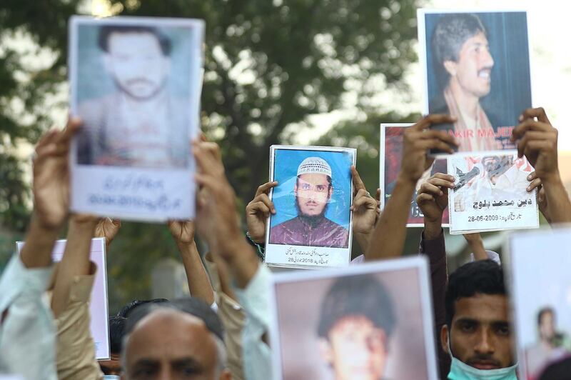Families of missing people hold pictures of their relatives during a protest in front of the Karachi press club in Pakistan. EPA