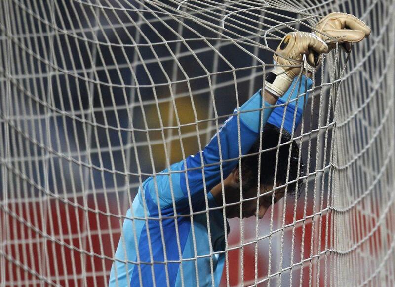 Egypt keeper Sherif Ekrami reacts after the final on Tuesday night, as the Egyptians' 24-year World Cup drought was extended by another four. Amr Abdallah Dalsh / Reuters