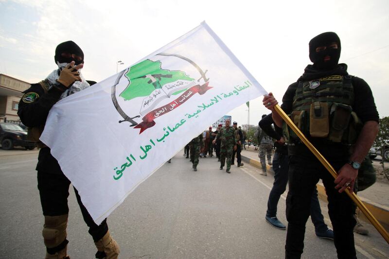 Iraqi Shiite members of the Asaib Ahl al-Haq group (The League of the Righteous) units gather in the southern city of Basra on December 12, 2015, to demand the withdrawal of Turkish forces from Iraq. Iraq says Turkey deployed troops and tanks to a base in the country's north last week without its permission, sparking a diplomatic uproar between Baghdad and Ankara. (Photo by HAIDAR MOHAMMED ALI / AFP)