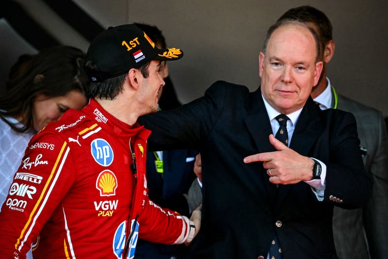 Race winner Ferrari's Monegasque driver Charles Leclerc celebrates with Prince Albert II of Monaco. AFP