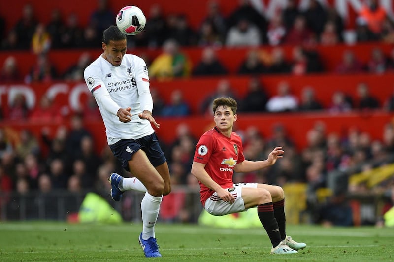 Liverpool defender Virgil van Dijk heads the ball as Manchester United's Daniel James chases. AFP