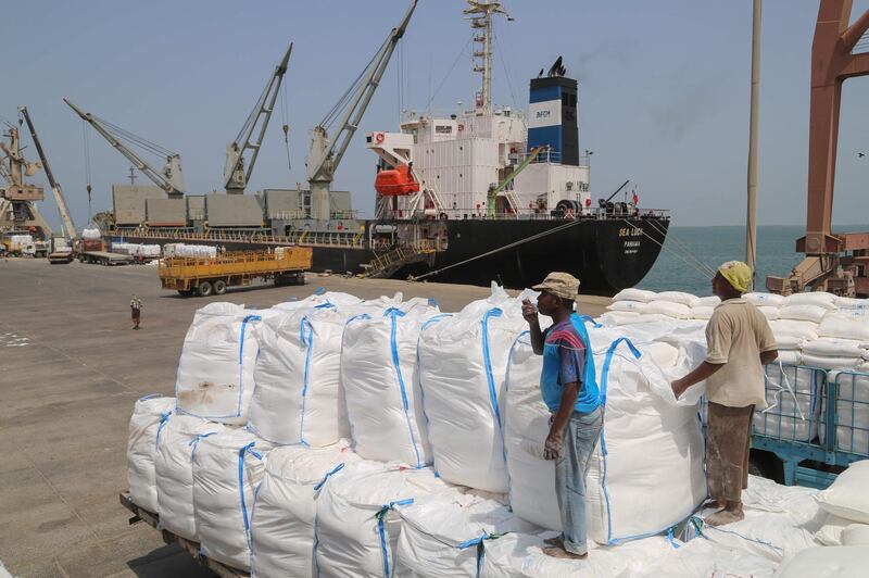 Yemenis receive sacks of food aid packages from the World Food Programme (WFP) in the Yemeni port city of Hodeida on June 25, 2019. The escalation of attacks by Iran-aligned Huthi rebels on Saudi cities threatens a hard-won UN-sponsored ceasefire deal for the Red Sea port city of Hodeida, war-ravaged Yemen's main conduit for humanitarian aid. / AFP / -
