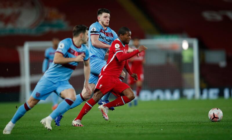 Georginio Wijnaldum of Liverpool runs with the ball under pressure from Declan Rice. Getty Images