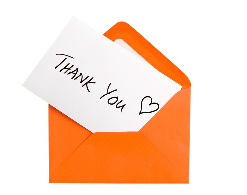 Thank You note in Orange envelope. Isolated on white. Getty Images