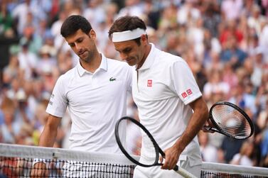 Novak Djokovic, left, commiserates with Roger Federer after beating the Swiss in the Wimbledon final. EPA