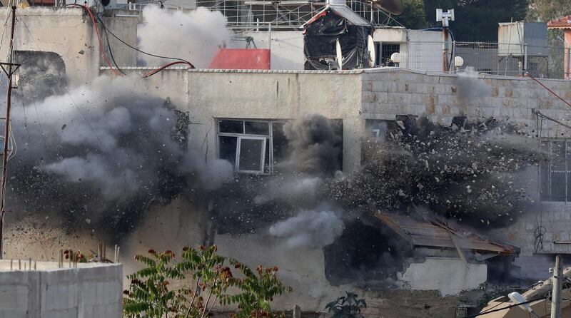 Smoke rises as Israeli troops blow up the house of Palestinian Abu Laila family, in al-Zawiya village near the west bank city of Salfit. EPA
