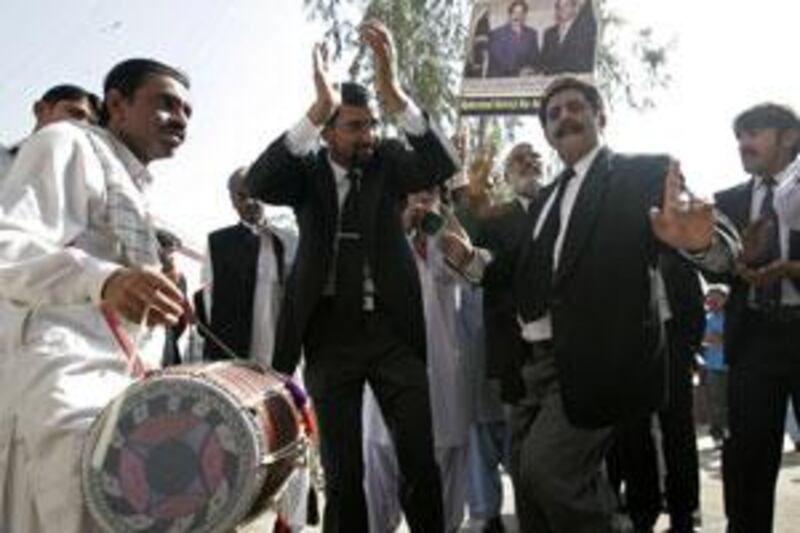 Lawyers dance as they celebrate  the government's decision to reinstate Iftikhar Chaudhry as chief justice, in Hyderabad March 16, 2009.