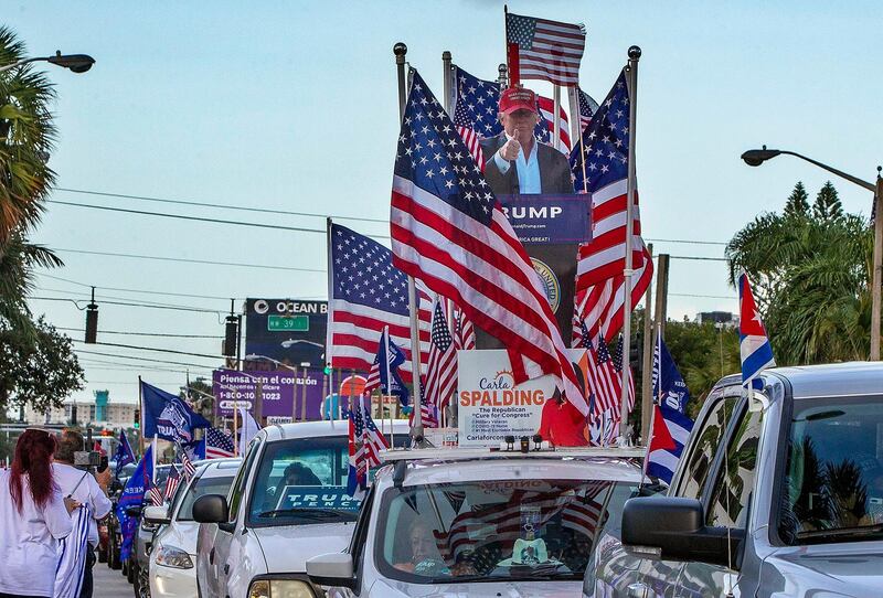 A caravan supporting President Trump drives around Miami streets. Miami Herald via AP