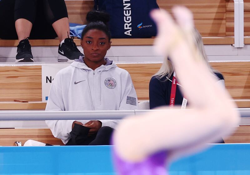 Simone Biles of the United States watches from the stands.