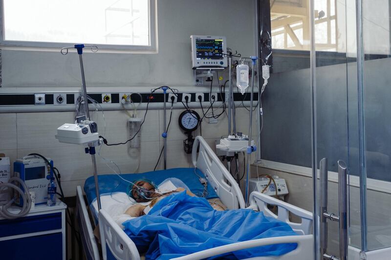 January 15th, 2019 - Kabul, Kabul, Afghanistan: Tooryalai Lal Mohammad, 25, lays in a hospital bed in the Wazir Akbar Khan public hospital. He was wounded when an explosion went off outside of Green Village. He has wounds on his arms, legs, chest and back. Doctors are still unable to fully diagnose his wounds has they do not have a portable x-ray machine and Tooryalai could not be transported to the machine.

The attack on the Green Village, a compound in Kabul that houses foreign workers and NGO's, initially killed 9 and wounded over 120 Afghans who lived in the vicinity. There was also extensive property damage to the surrounding homes and shops. 

Ivan Flores/The National