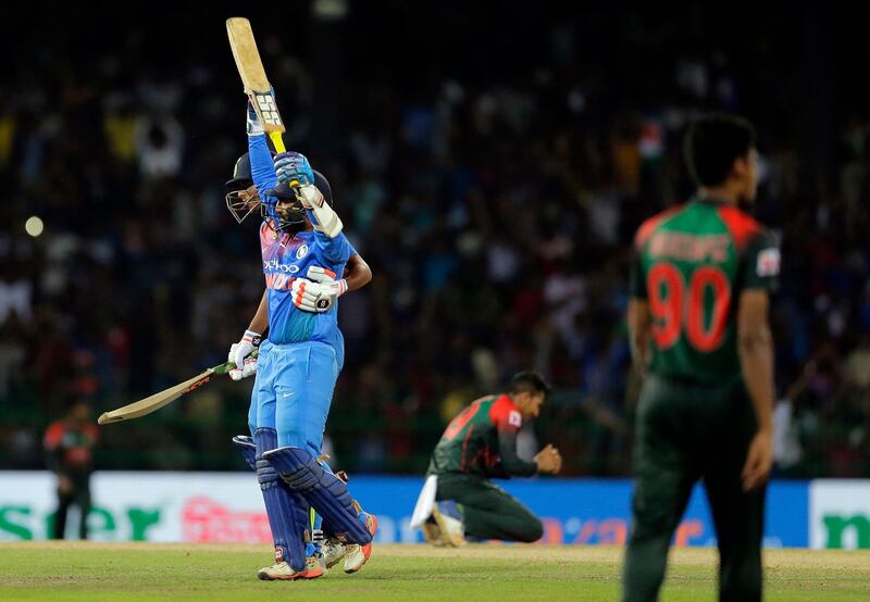India's Dinesh Karthik, left, celebrates scoring the winning run to defeat Bangladesh by four wickets during the finals of Nidahas triangular Twenty20 cricket series in Colombo, Sri Lanka, Sunday, March 18, 2018. (AP Photo/Eranga Jayawardena)