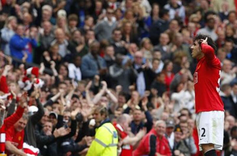 Carlos Tevez cups his ears to the applause of the Old trafford crowd after scoring Manchester United's second goal in their 2-0 win over Manchester City.