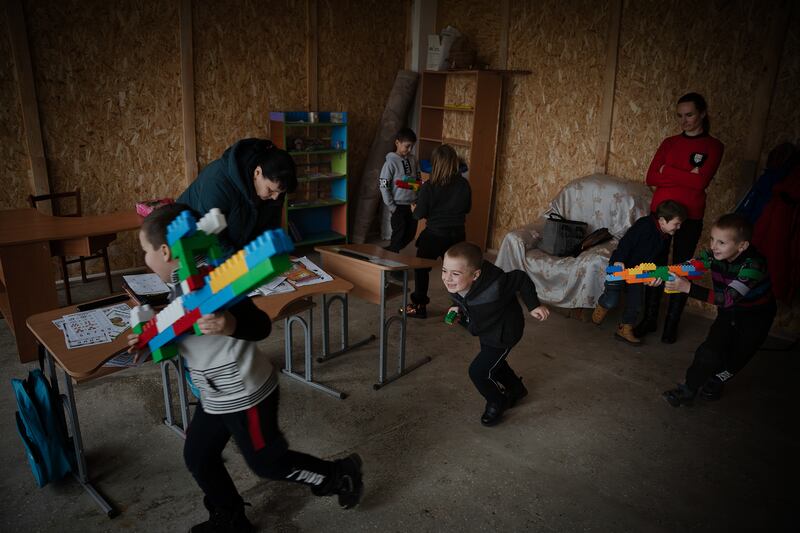 Classmates play with rifles made from Lego blocks after school, in Vysokopillya, December 2023. Getty Images