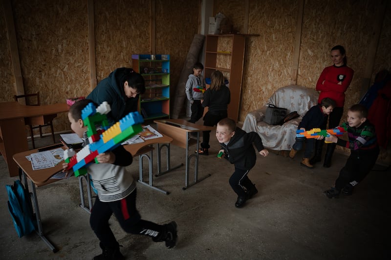Classmates play with rifles made from Lego blocks after school, in Vysokopillya, December 2023. Getty Images