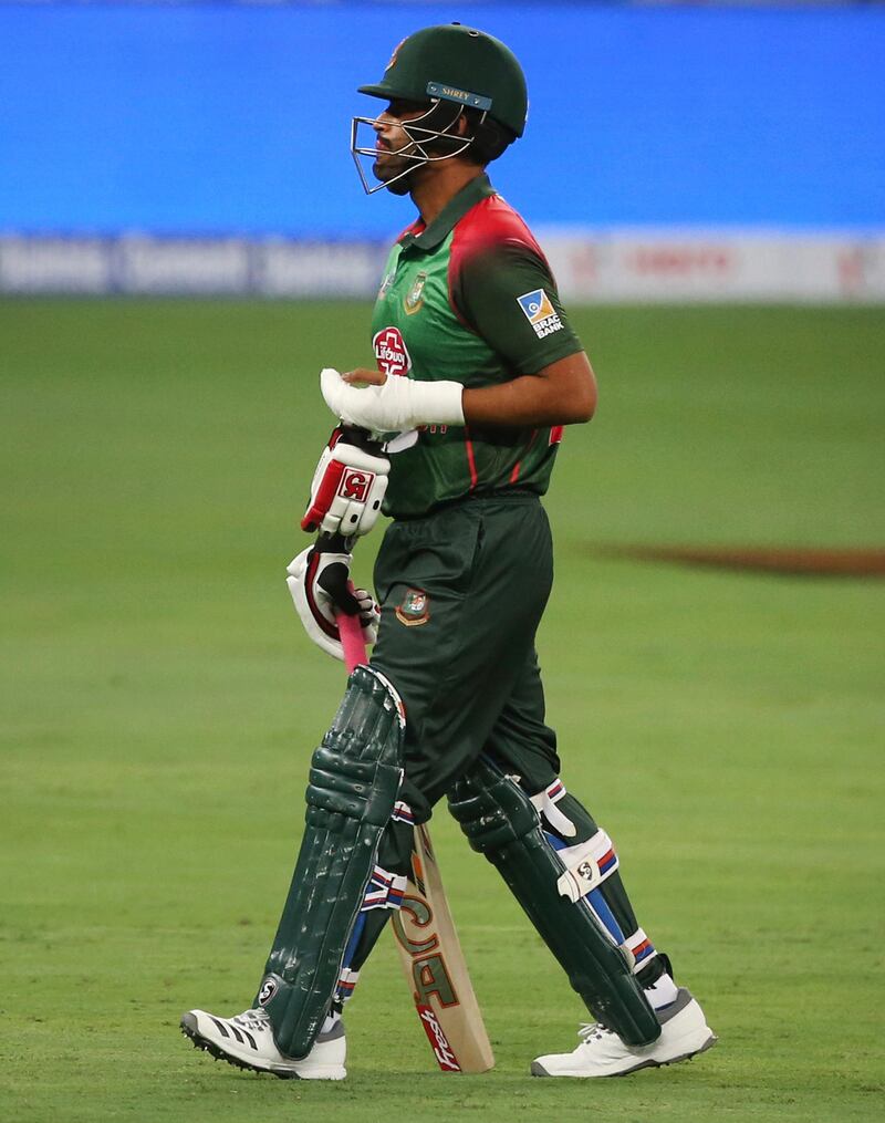 Bangladesh's Tamim Iqbal with his injured left hand covered in an orthopedic cast leaves the field at the end of first innings during the one day international cricket match of Asia Cup between Sri Lanka and Bangladesh in Dubai, United Arab Emirates, Saturday, Sept. 15, 2018. (AP Photo/Aijaz Rahi)