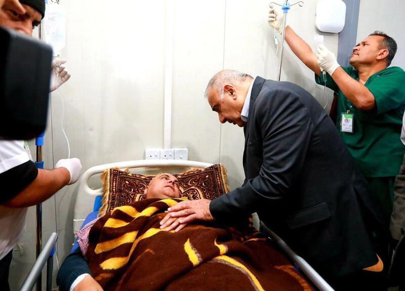 Iraqi Prime Minister Adel Abdel Mahdi visits the people who survived the disaster. EPA