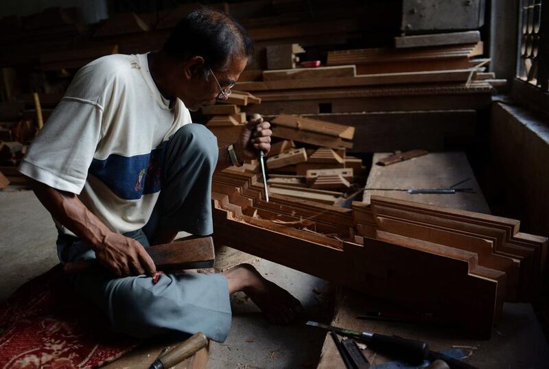 Nepalese woodcarver Hari Bahadur Shilpakar works in a workshop in Bhaktapur on the outskirts of Kathmandu. Prakash Mathema / AFP