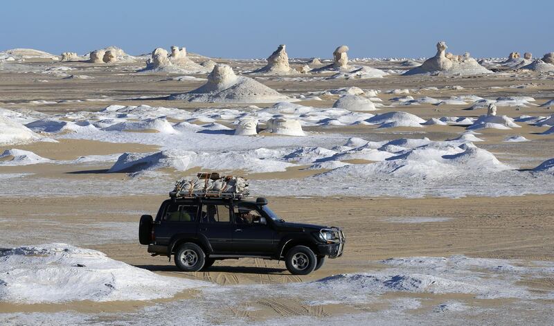 Desert safari vehicles drive along the White Desert in Egypt. EPA