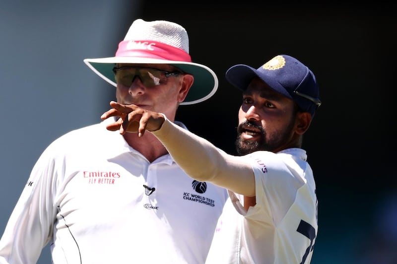 SYDNEY, AUSTRALIA - JANUARY 10: Mohammed Siraj of India stops play to make a formal complaint to Umpire Paul Reiffel about some spectators in the bay behind his fielding position during day four of the Third Test match in the series between Australia and India at Sydney Cricket Ground on January 10, 2021 in Sydney, Australia. (Photo by Cameron Spencer/Getty Images)