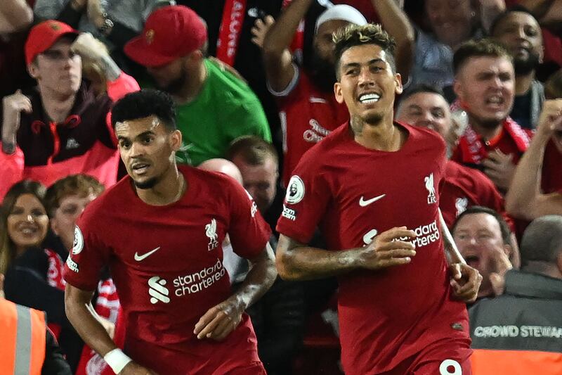 Roberto Firmino, right, celebrates after scoring for Liverpool. AFP