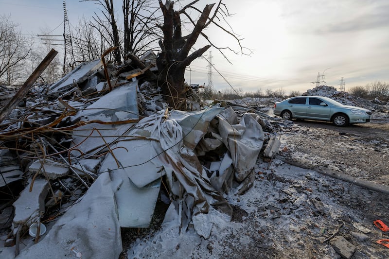 A car drives past a destroyed building purported to have been used as temporary accommodation for Russian soldiers, dozens of whom were killed in a Ukrainian missile strike in Makiivka, Russian-controlled Ukraine. Reuters