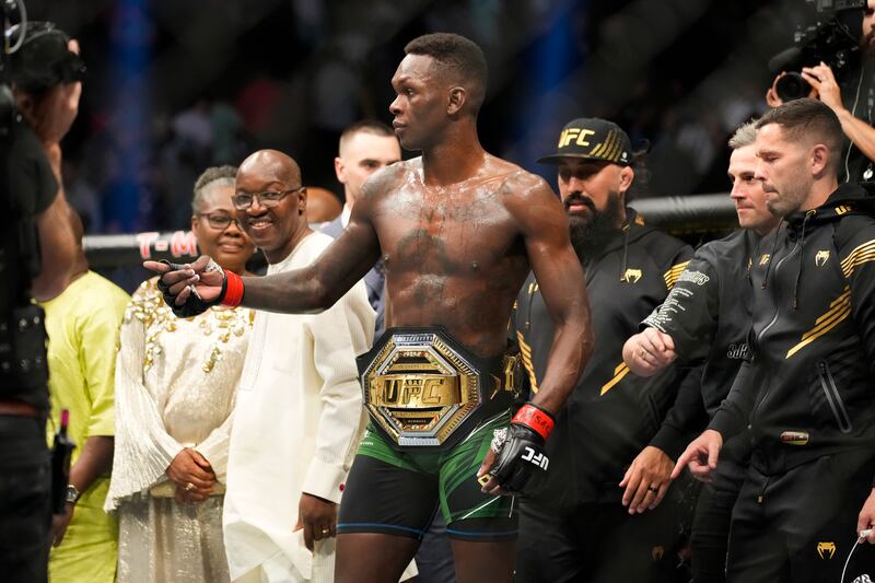 Israel Adesanya celebrates after retaining his middleweight title against Jared Cannonier at UFC 276. AP