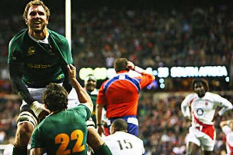 Andries Bekker congratulates Jaque Fourie after he scored one of the South African tries against England at Twickenham.