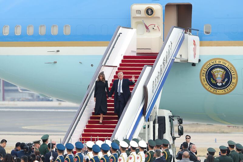 US president Donald Trump and first lady Melania Trump descend from Air Force One as they arrive in Beijing. Lintao Zhang / AFP Photo