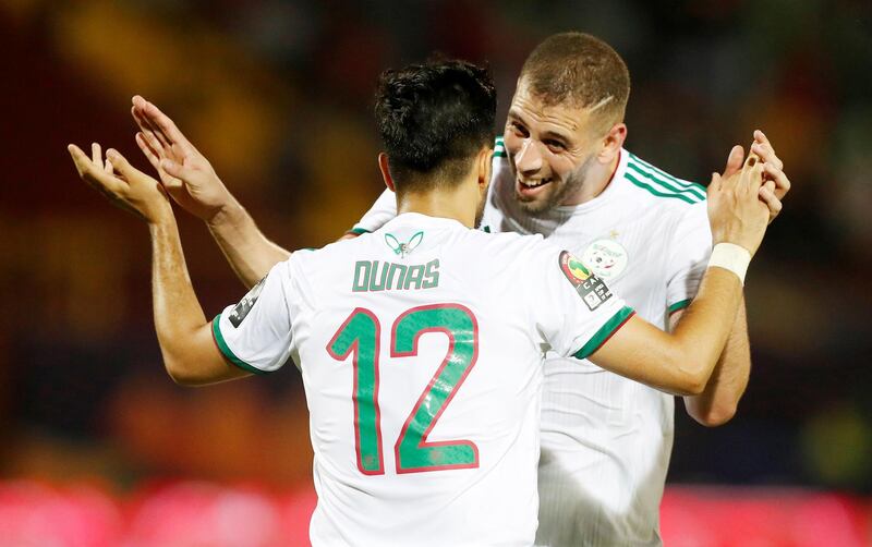 Algeria's Adam Ounas celebrates scoring their second goal with Islam Slimani, who scored Algeria's other two goals in a 3-0 victory over Tanzania on Monday. Reuters
