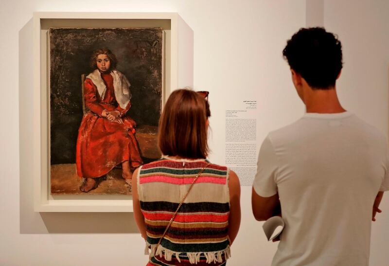 Visitors observe 'The Barefoot Girl' (1895), an earlier work by Picasso before the artist moved to Paris and developed Cubism. Joseph Eid / AFP