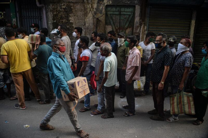 People queue to buy alcohol after the government of India's West Bengal's state announced a 15-day lockdown amid the Covid-19 pandemic, in Siliguri. AFP