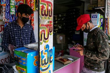 A shop worker and a supplier wear masks as protection against Covid-19, in Bengaluru, Karnataka state, India. Concerns have been raised about the new Delta Plus variant. Bloomberg