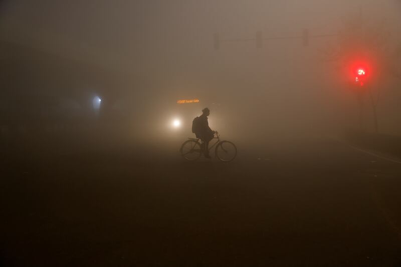 A man rides a bicycle amid heavy fog in New Delhi, India. Reuters