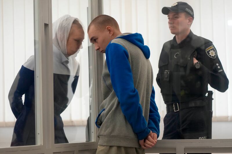 Russian Sgt Vadim Shishimarin listens to his translator during his court hearing in Kyiv on May 23. The 21-year-old soldier pleaded guilty to killing an unarmed civilian.  AP