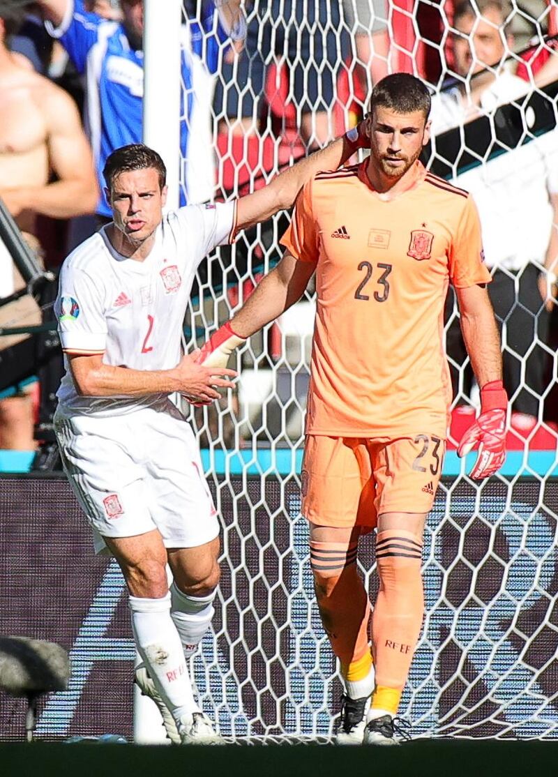Spain defender Cesar Azpilicueta gives goalkeeper Unai Simon some support after his blunder.