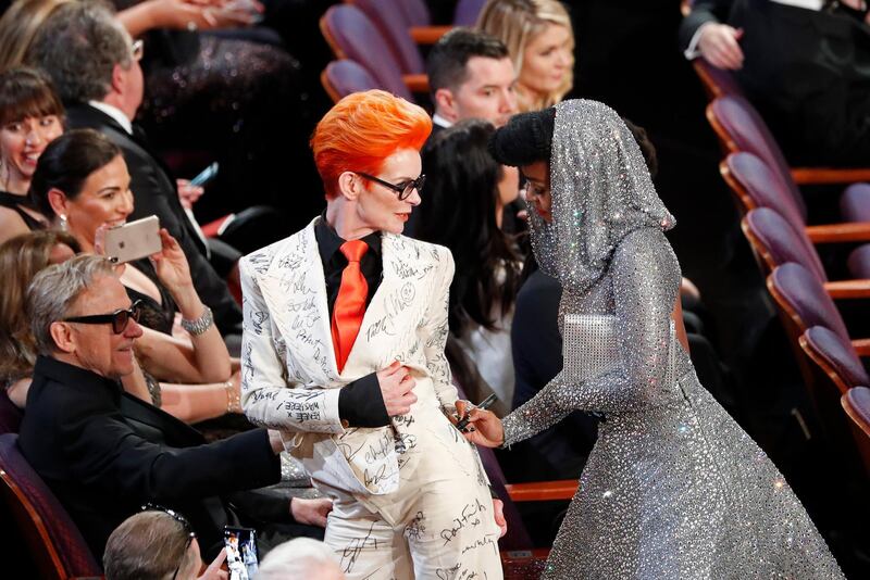 Janelle Monae signs Sandy Powell's outfit during the Oscars show at the 92nd Academy Awards in Hollywood, Los Angeles. Reuters