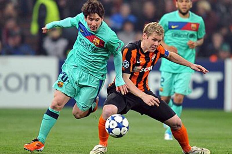 Barcelona's Lionel Messi, left, battles for the ball with Shakhtar's Tomas Hubschman during the second-leg of their Champions League quarter-final.