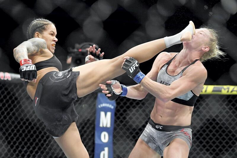 Jul 6, 2019; Las Vegas, NV, USA; Amanda Nunes (red gloves) lands a kick to the face of Holly Holm (blue gloves) at T-Mobile Arena. Mandatory Credit: Stephen R. Sylvanie-USA TODAY Sports     TPX IMAGES OF THE DAY