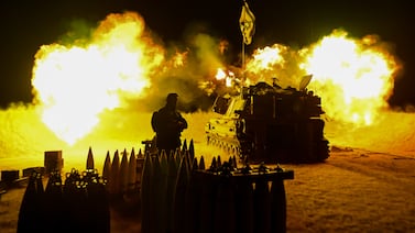 An Israeli artillery unit fires towards Gaza on December 11 from southern Israel. Getty