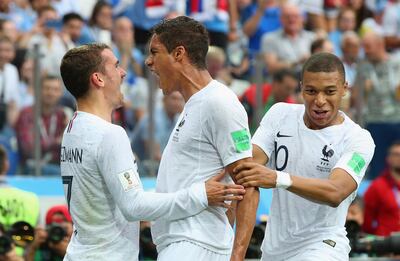 NIZHNY NOVGOROD, RUSSIA - JULY 06:  Raphael Varane of France celebrates with team mates Kylian Mbappe and Antoine Griezmann after scoring his team's first goal during the 2018 FIFA World Cup Russia Quarter Final match between Winner Game 49 and Winner Game 50 at Nizhny Novgorod Stadium on July 6, 2018 in Nizhny Novgorod, Russia.  (Photo by Alex Livesey/Getty Images)