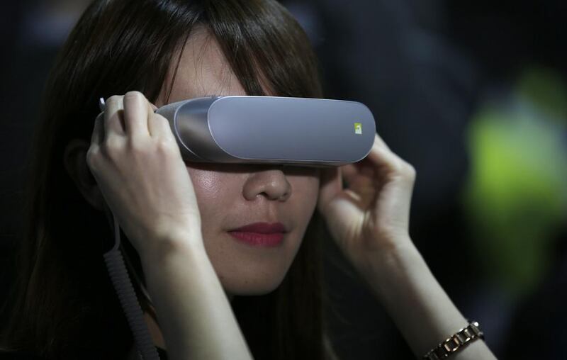 A woman uses the LG 360 VR headset during the LG unpacked 2016 event at the Mobile World Congress wireless show, in Barcelona. Manu Fernandez / AP Photo