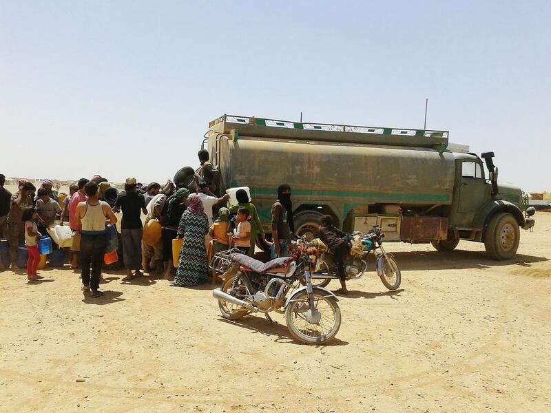 The daily drudgery of water collection at Rukban. AP 