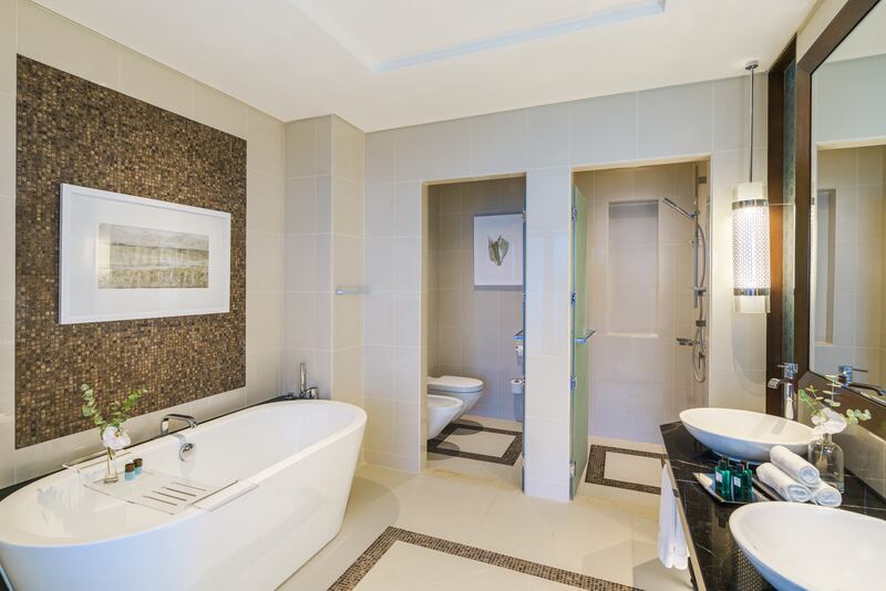 The bathroom features a large standalone bathtub