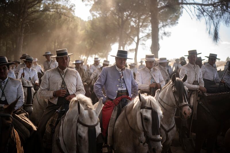 Pilgrims ride their horses in Donana National Park on their way to the shrine of El Rocio in Almonte, Spain. The annual pilgrimage leads thousands of devotees of the Virgin del Rocio to converge in and around the shrine. AP