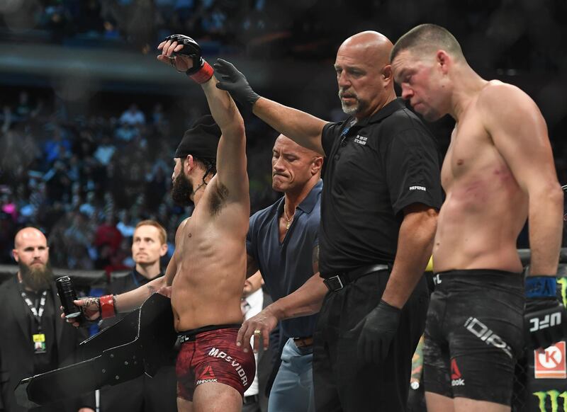 Dwayne Johnson puts the BMF belt on Jorge Masvidal after he defeated Nate Diaz at UFC 244. Reuters