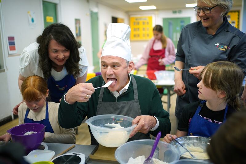 Mr Davey takes part in a baking lesson with pupils from High Beeches Primary School during a half-term holiday camp in Hertfordshire. PA