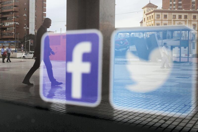 Facebook and Twitter logos are seen on a shop window in Malaga, Spain, June 4, 2018. REUTERS/Jon Nazca