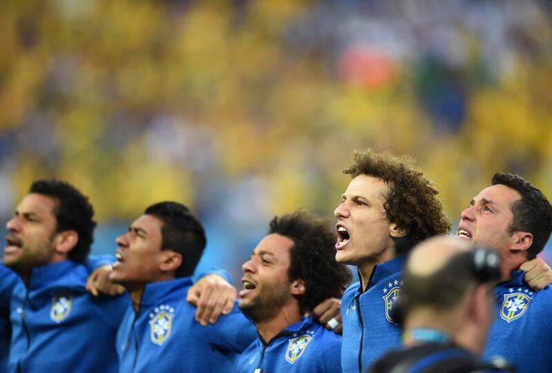 David Luiz, second from right, sings Brazil's national anthem with teammates prior to the start of the first match of the 2014 World Cup on Thursday at Arena Corinthians in Sao Paulo, Brazil. Christopher Lee / Getty Images